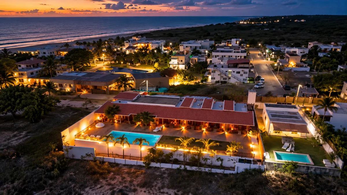 Aerial view of Santa Maria Inn with the sea in the background at dusk